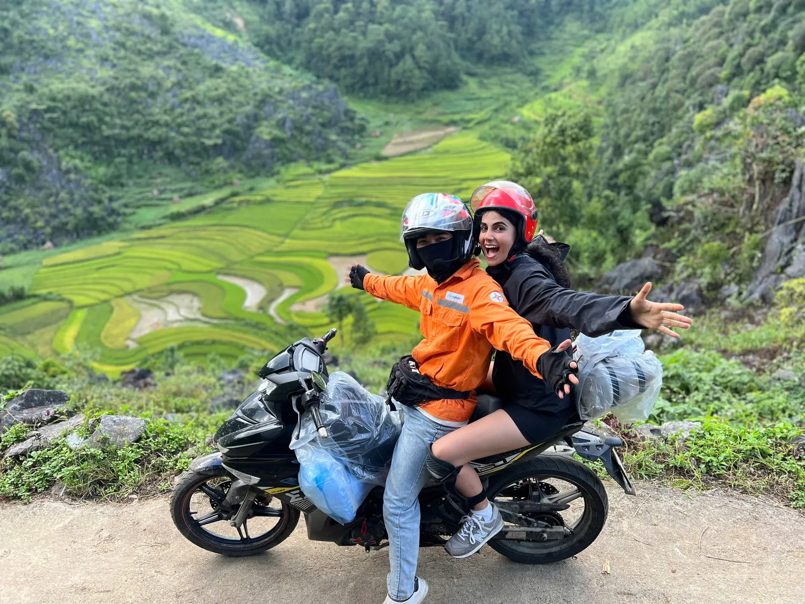 Easy rider and tourist on the bikes with paddy fields and moutain view around